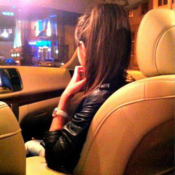 A girl in car with hand on chin