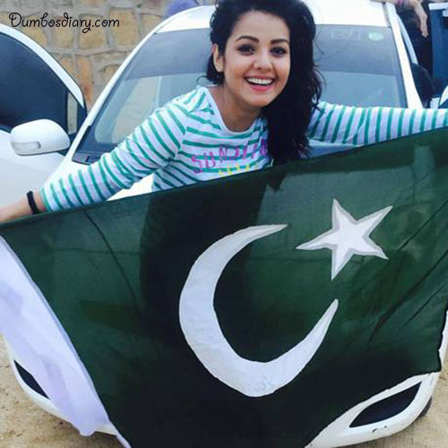 A happy girl holding Pakistani Flag