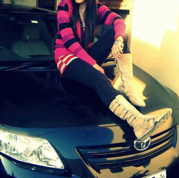 Fashion and stylish girl sitting on car