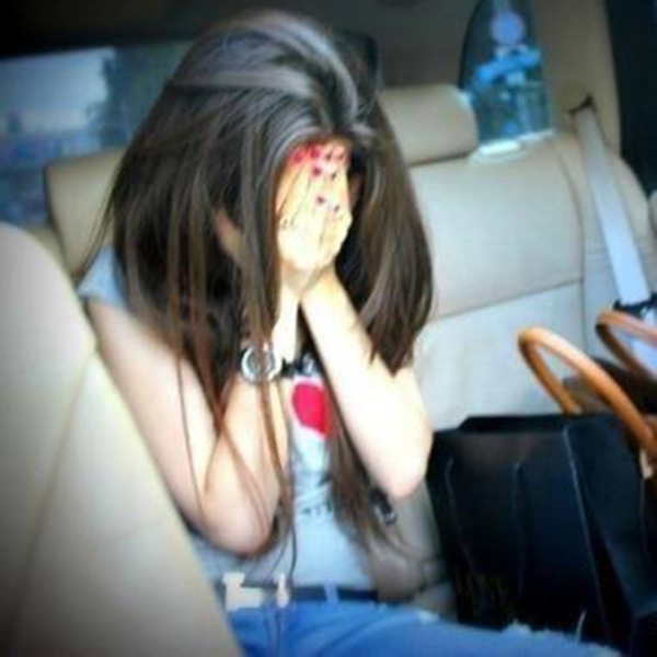 Girl in car hidding her face