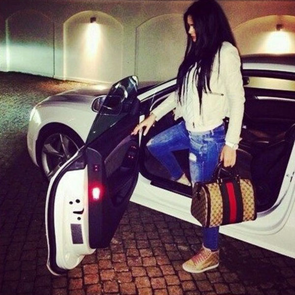 Girl in car with handbag in hand