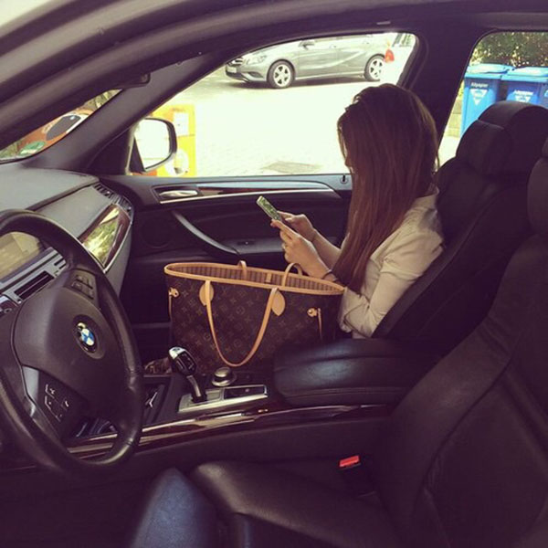 Girl using mobile in car