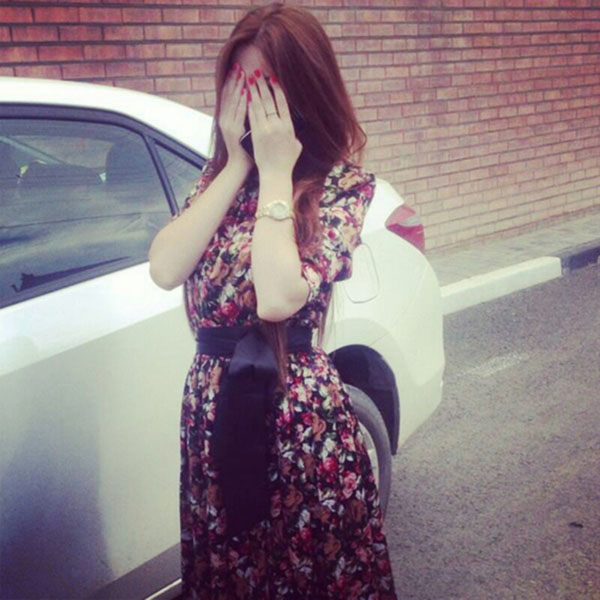 Girl with car hiding face with hands