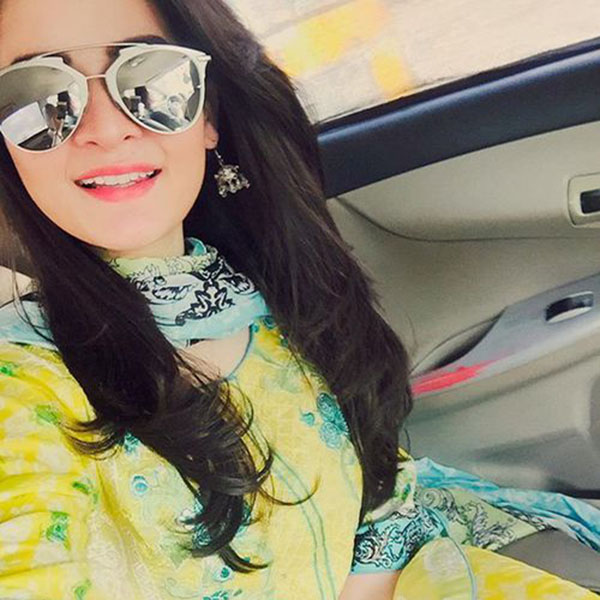 Girl with sunglasses taking selfie in car