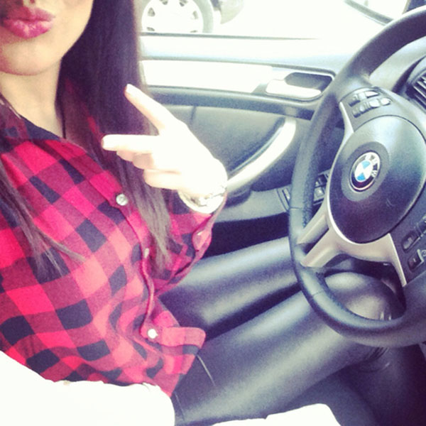 Red shirt girl in car taking selfie