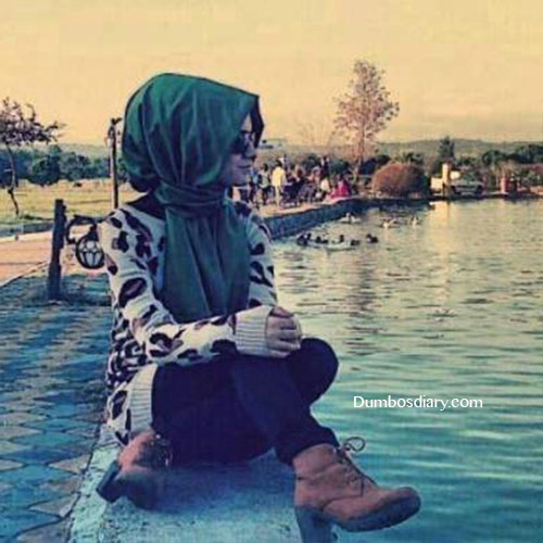 beautiful hijabi girl sitting on beach