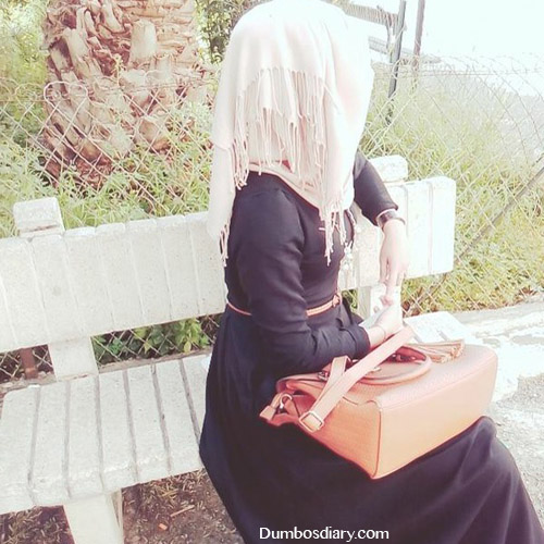 hijabi girl sitting in garden