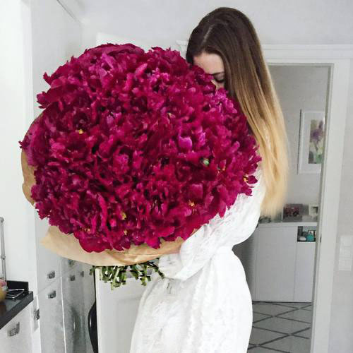 cute-girl-smelling-roses-bouquet