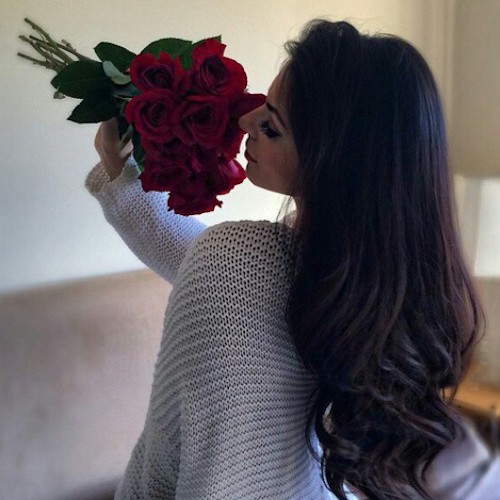 girl-smelling-roses
