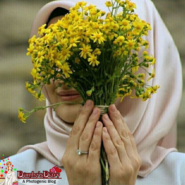 Hijabi-girl-hiding-face-with-flowers