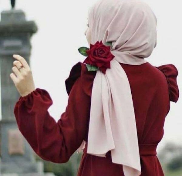 back of pretty hijabi girl holding rose
