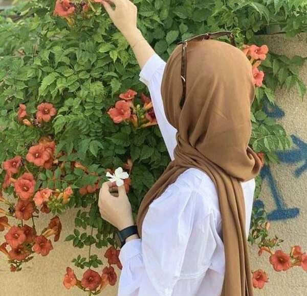 brown hijabi girl-plucking flower